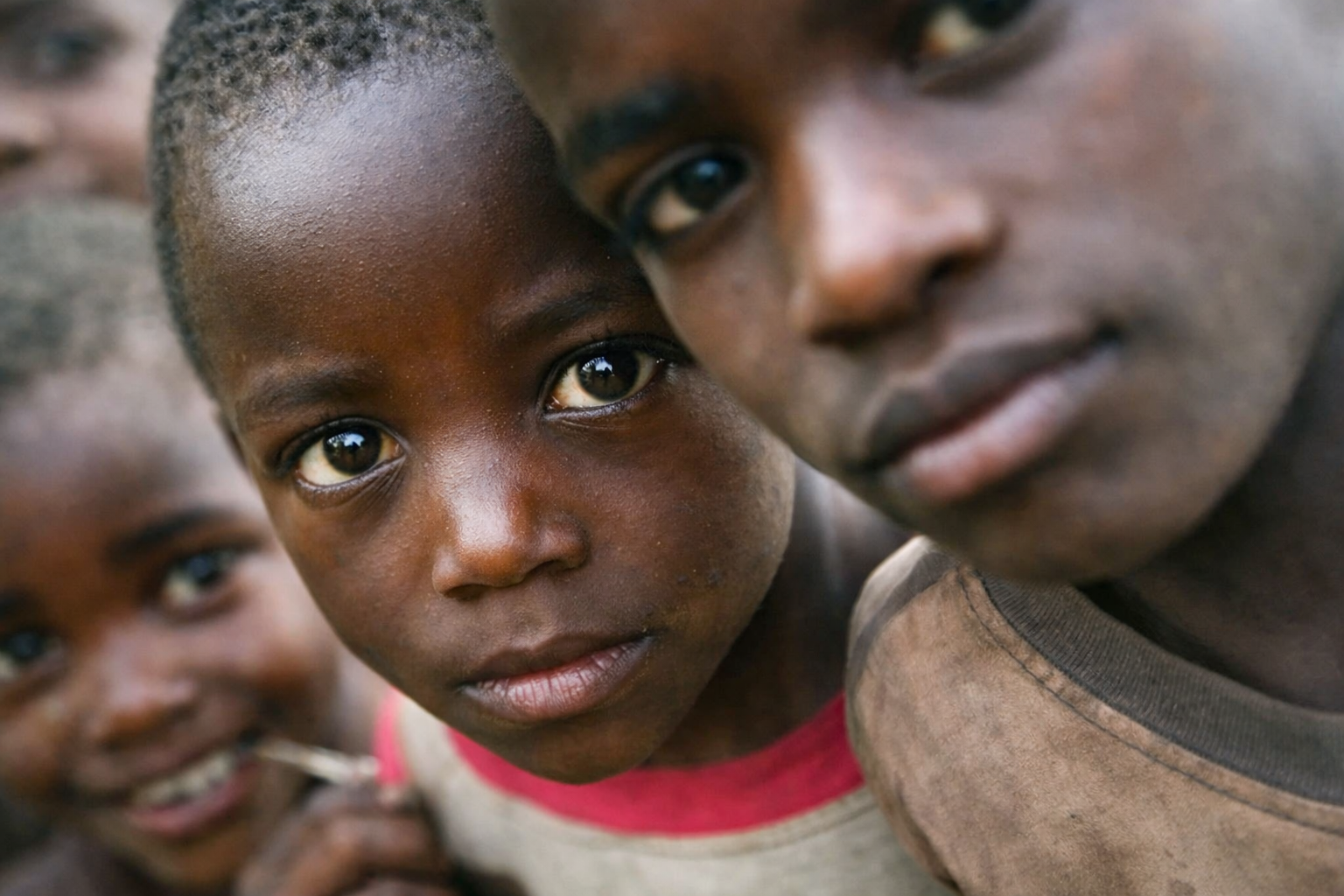 A little boy laughing while reading the Holy Bible